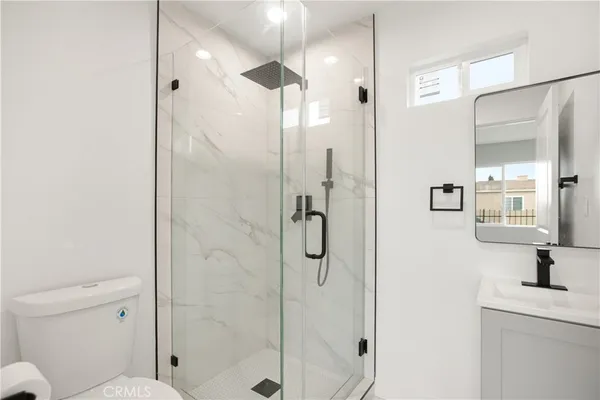 a bathroom with a shower and a toilet