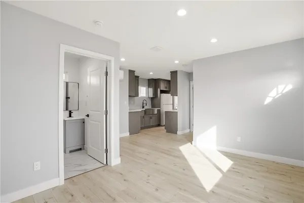 a view of a kitchen with a refrigerator and a sink