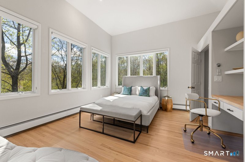 30 Catbrier Road Weston, CT 06883 - Photo 20 of 26 a bedroom with a bed a large window and wooden floor