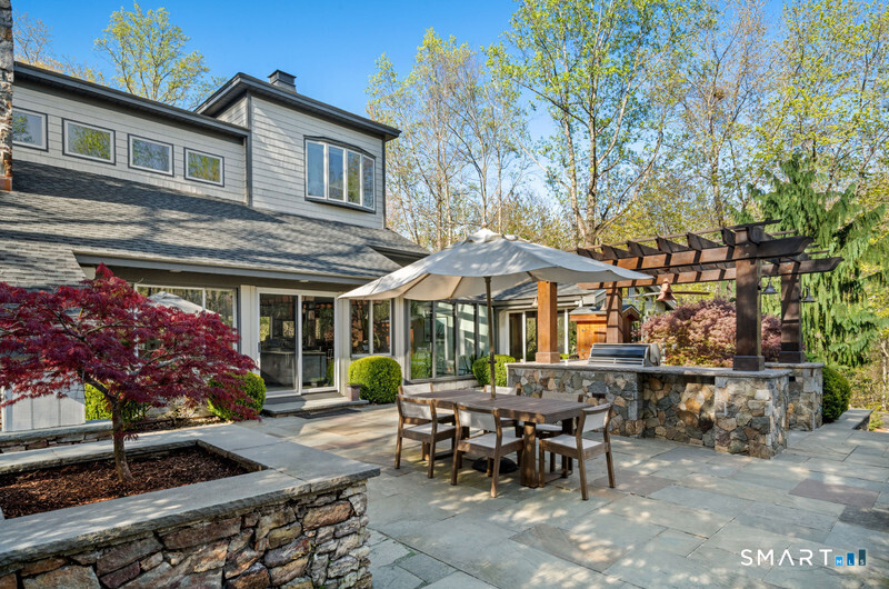 30 Catbrier Road Weston, CT 06883 - Photo 23 of 26 a view of a house with a chairs and table in a patio