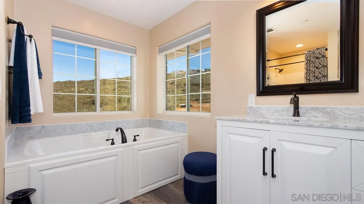 12951 Rancho Heights Road Pala, CA 92059 - Photo 22 of 41 a bathroom with a granite countertop sink mirror and vanity