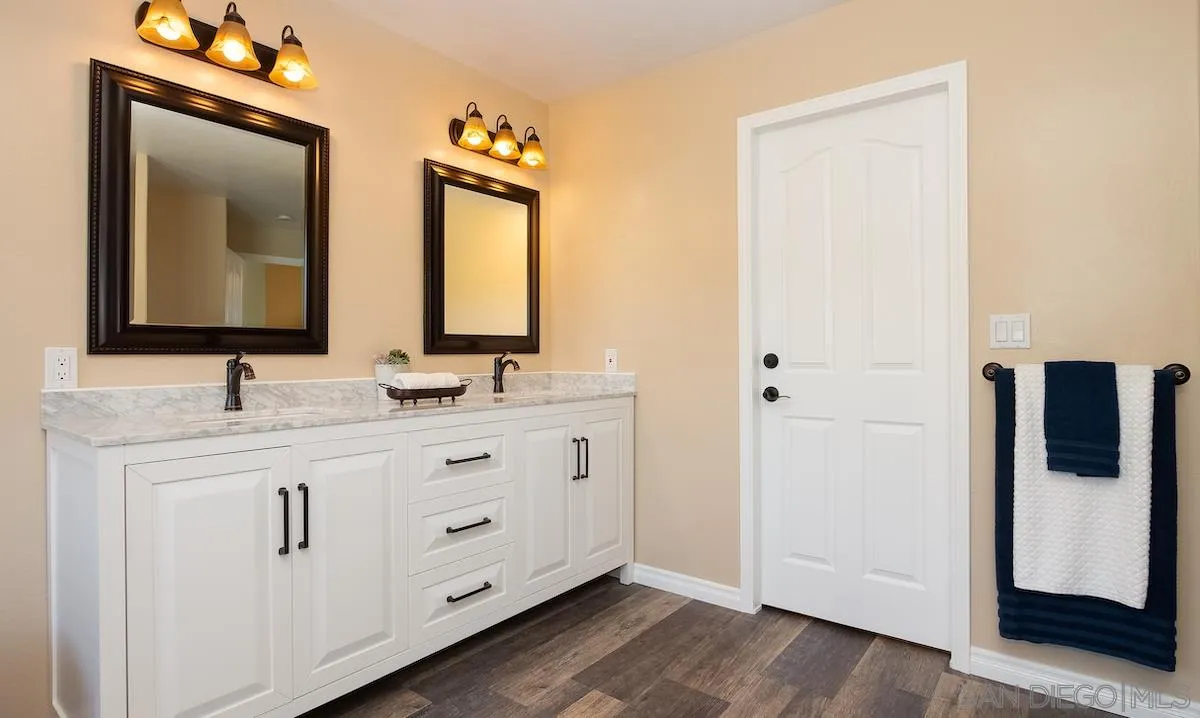 12951 Rancho Heights Road Pala, CA 92059 - Photo 24 of 41 a bathroom with a double vanity sink and mirror