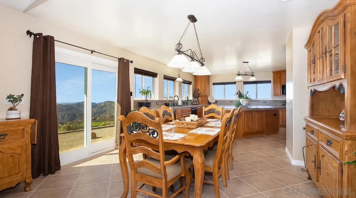 12951 Rancho Heights Road Pala, CA 92059 - Photo 7 of 41 a dining room with furniture a chandelier and a rug