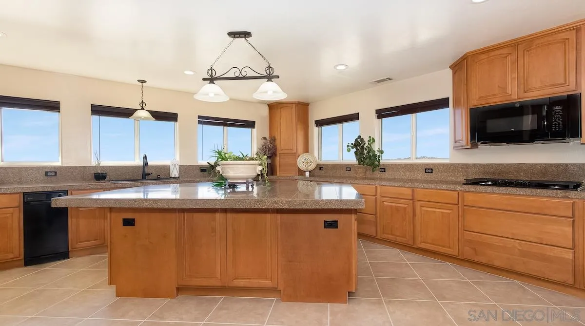 12951 Rancho Heights Road Pala, CA 92059 - Photo 10 of 41 a kitchen with stainless steel appliances granite countertop a sink and cabinets