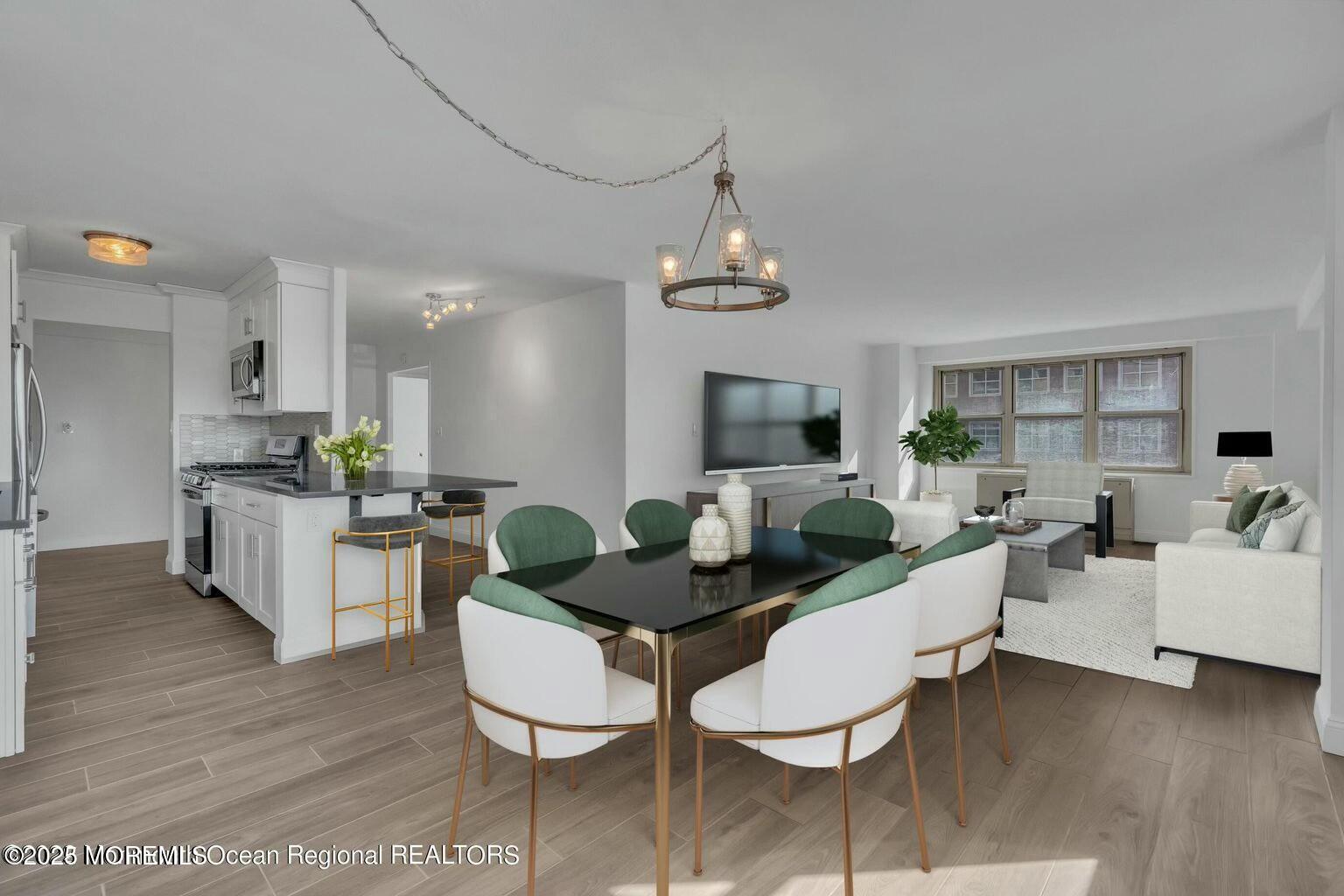 a living room with furniture kitchen view and a chandelier