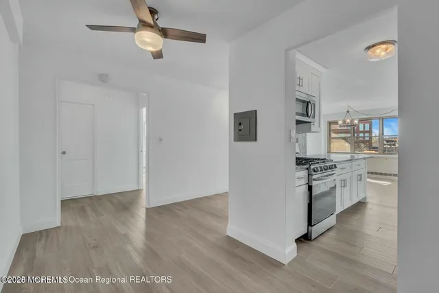 a kitchen with a refrigerator and a stove top oven