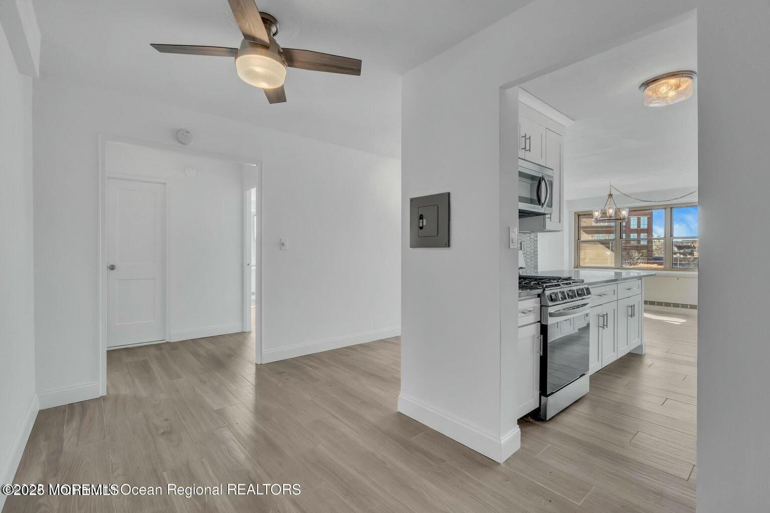 28 Riverside Avenue, Unit 1G Red Bank, NJ 07701 - Photo 11 of 25 a kitchen with a refrigerator and a stove top oven