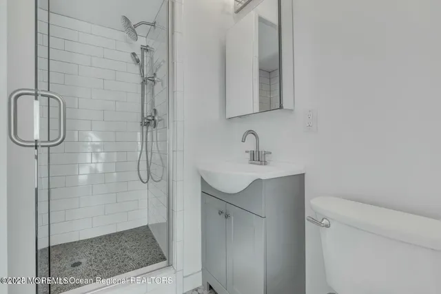 a bathroom with a shower sink and mirror