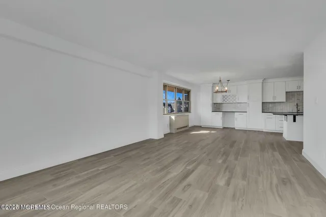a view of a kitchen with wooden floor and a sink