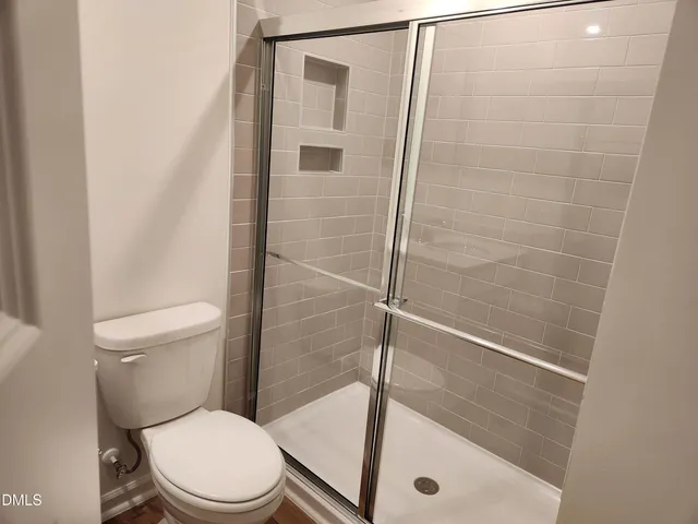 a white toilet sitting next to a bath tub