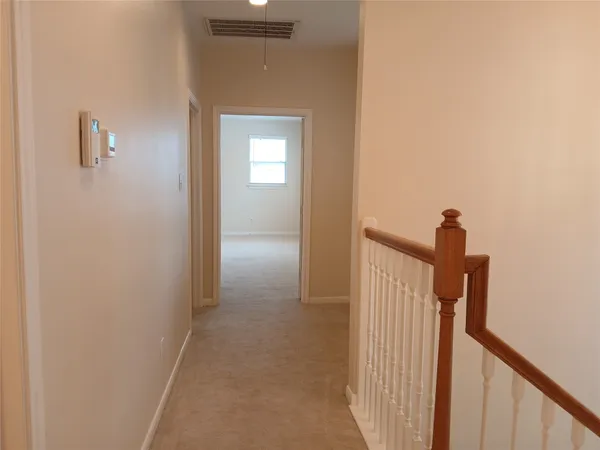 a view of a hallway view with staircase