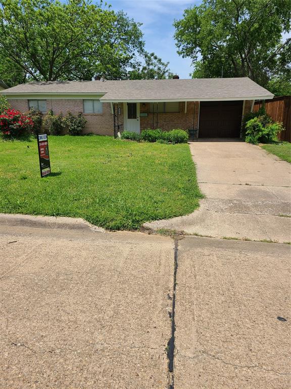 a front view of a house with a yard and a garage