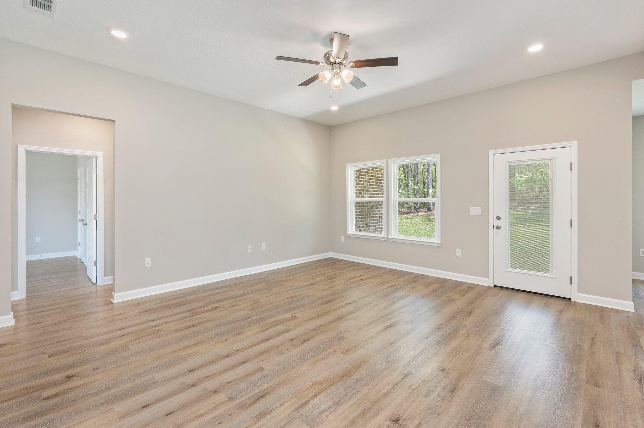2540 Kingston Road Crestview, FL 32536 - Photo 3 of 30 an empty room with wooden floor and windows