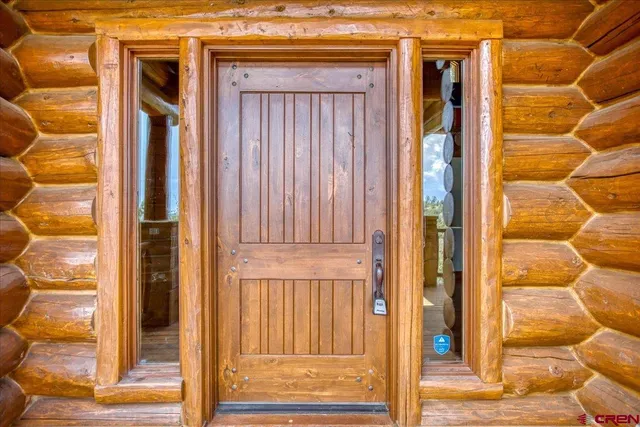 a living room with fireplace furniture and a large window