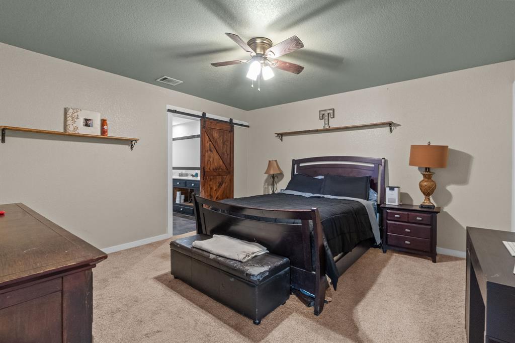 395 Private Road 4219 Decatur, TX 76234 - Photo 16 of 29 a bedroom with bed and window