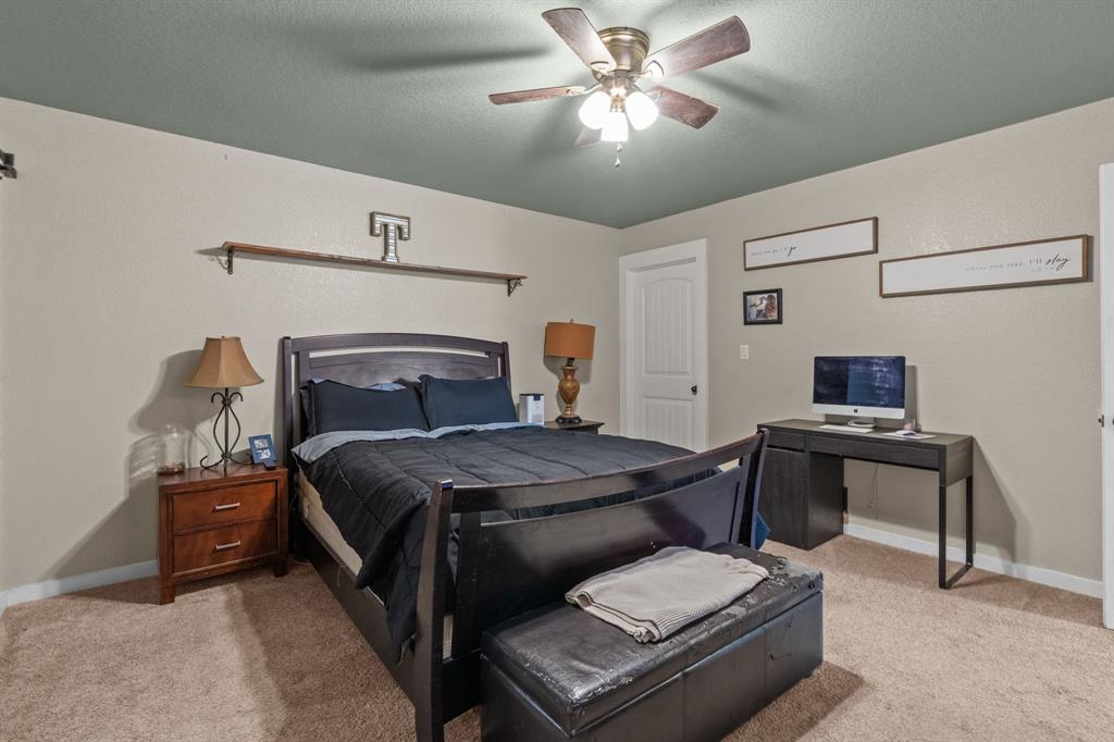 395 Private Road 4219 Decatur, TX 76234 - Photo 17 of 29 a bedroom with a bed and a chandelier