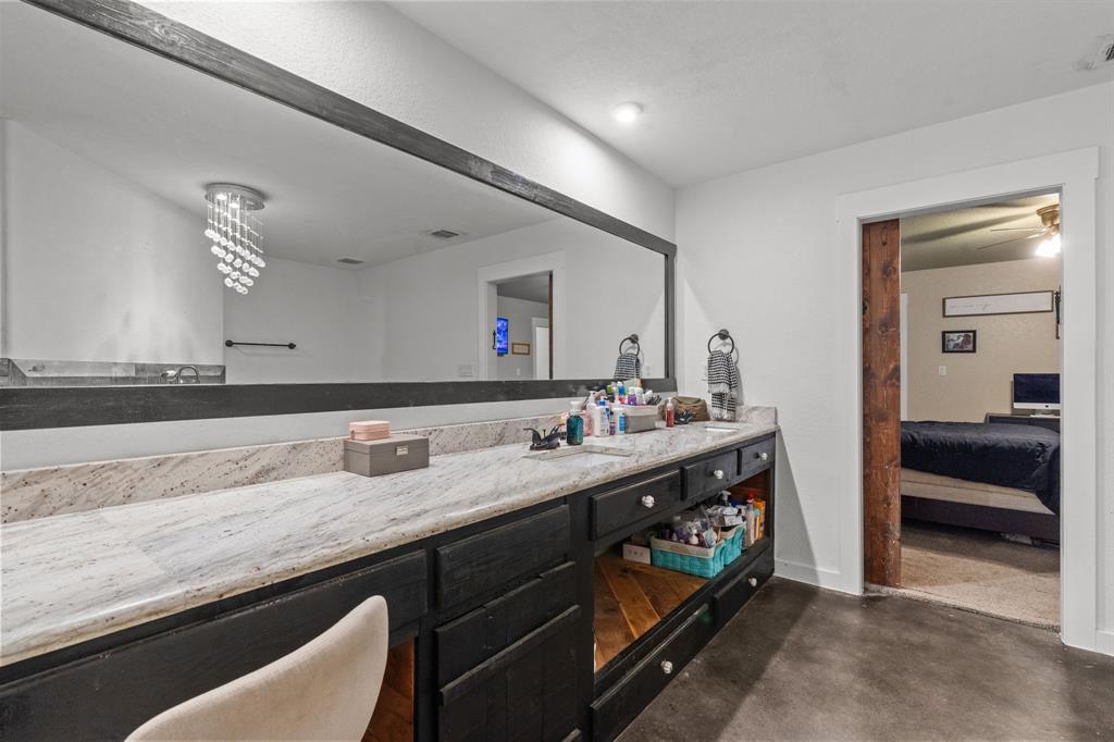 395 Private Road 4219 Decatur, TX 76234 - Photo 20 of 29 a en suite bathroom with double sink and a mirror