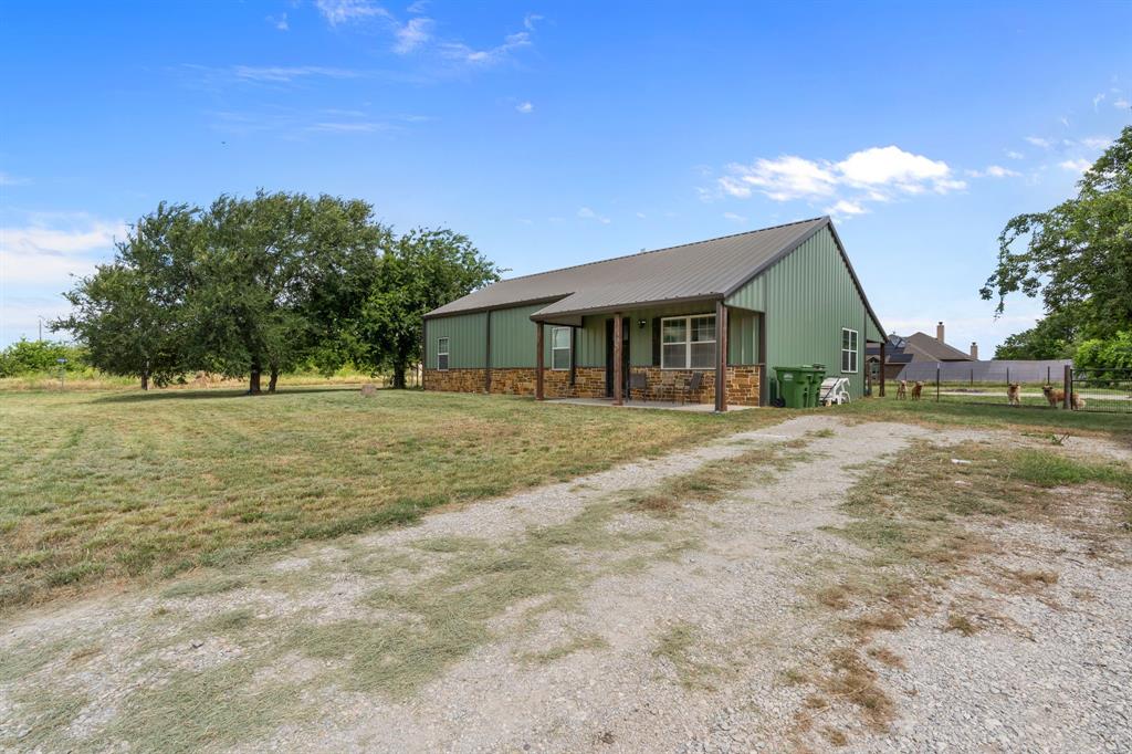 395 Private Road 4219 Decatur, TX 76234 - Photo 2 of 29 a front view of a house with a yard