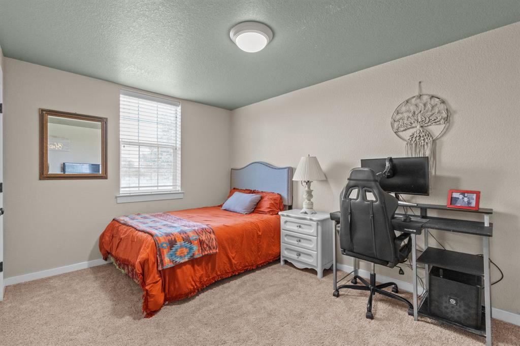 395 Private Road 4219 Decatur, TX 76234 - Photo 22 of 29 a bedroom with bed and a window