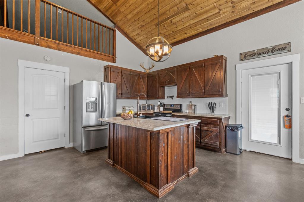 395 Private Road 4219 Decatur, TX 76234 - Photo 6 of 29 a kitchen with stainless steel appliances granite countertop a stove refrigerator and a sink