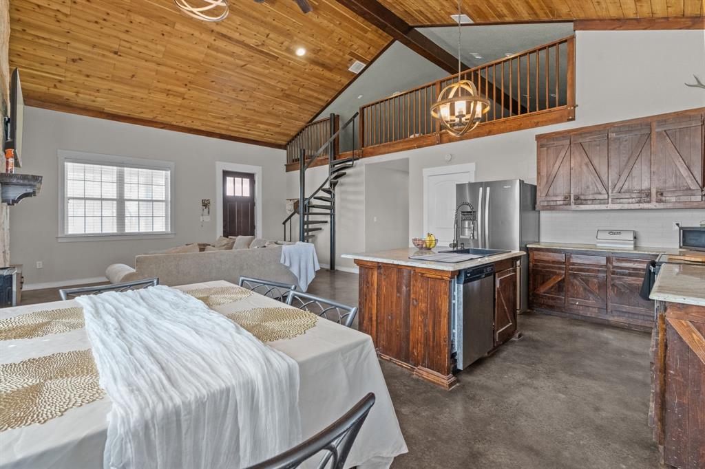 395 Private Road 4219 Decatur, TX 76234 - Photo 8 of 29 a bed room with a bed and a kitchen