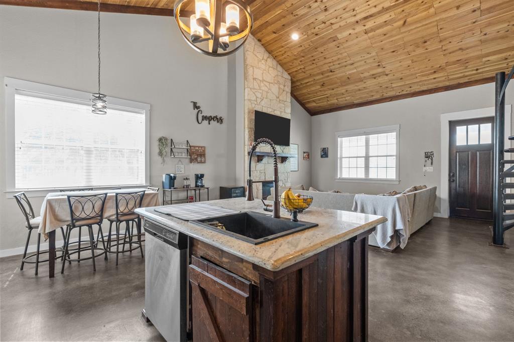 395 Private Road 4219 Decatur, TX 76234 - Photo 9 of 29 a kitchen with a table chairs and a chandelier