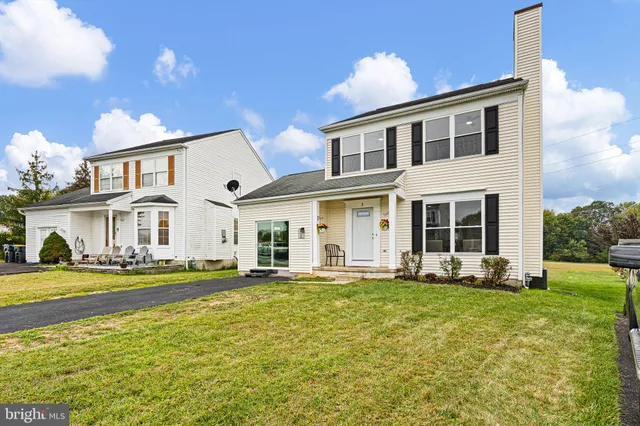 a front view of a house with a yard table and chairs