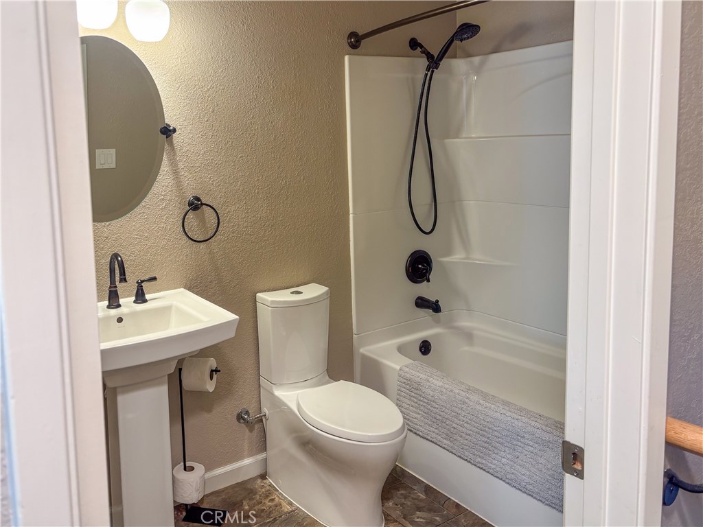 4125 Tranquilla Avenue Atascadero, CA 93422 - Photo 13 of 27 a bathroom with a sink toilet and shower