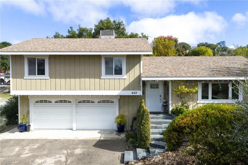 4125 Tranquilla Avenue Atascadero, CA 93422 - Photo 2 of 27 a front view of a house with a yard and garage