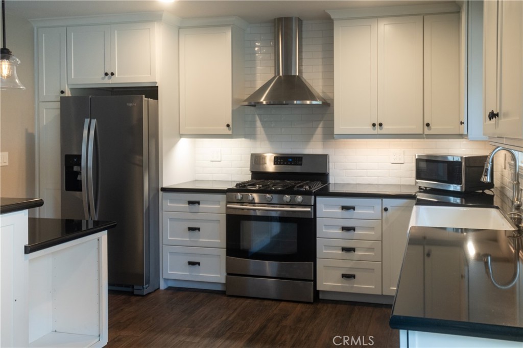 4125 Tranquilla Avenue Atascadero, CA 93422 - Photo 7 of 27 a kitchen with stainless steel appliances a stove a refrigerator and cabinets