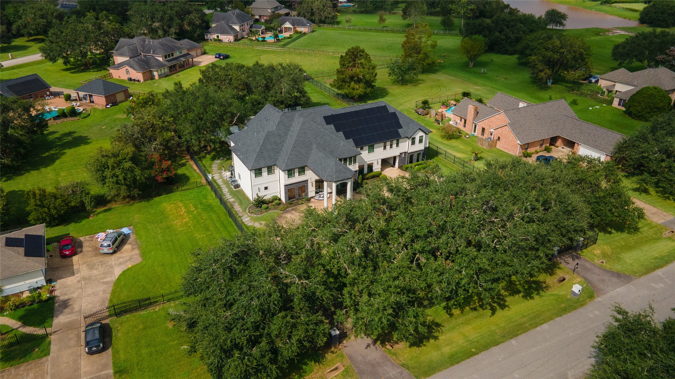 4002 Silver Ridge Boulevard Missouri City, TX 77459 - Photo 45 of 50 This is an aerial view of a spacious two-story home with a large, well-maintained lawn and mature trees, situated in a suburban neighborhood with similar properties.