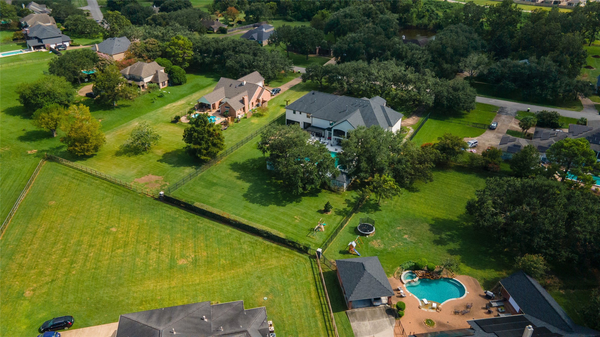 4002 Silver Ridge Boulevard Missouri City, TX 77459 - Photo 48 of 50 This aerial photo shows a spacious property in a lush, green residential area featuring large homes with generous yards, some with swimming pools, offering a sense of privacy and comfort.