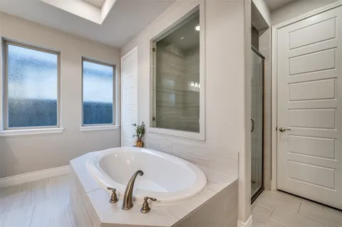 a bathroom with a tub and shower
