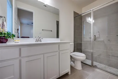 a bathroom with a sink toilet a mirror and shower