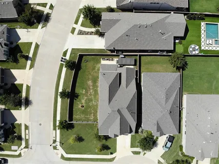an aerial view of a house with a swimming pool