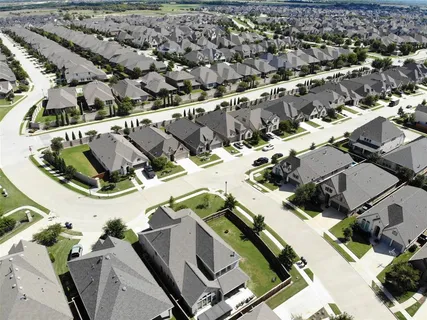 an aerial view of residential houses with outdoor space