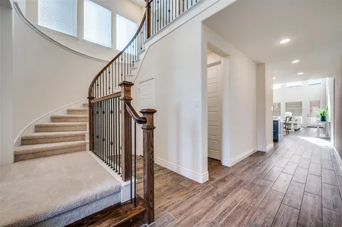 a view of entryway and hall with wooden floor