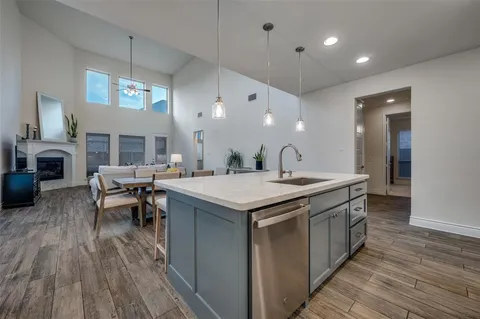 a kitchen with a stove and a wooden floor