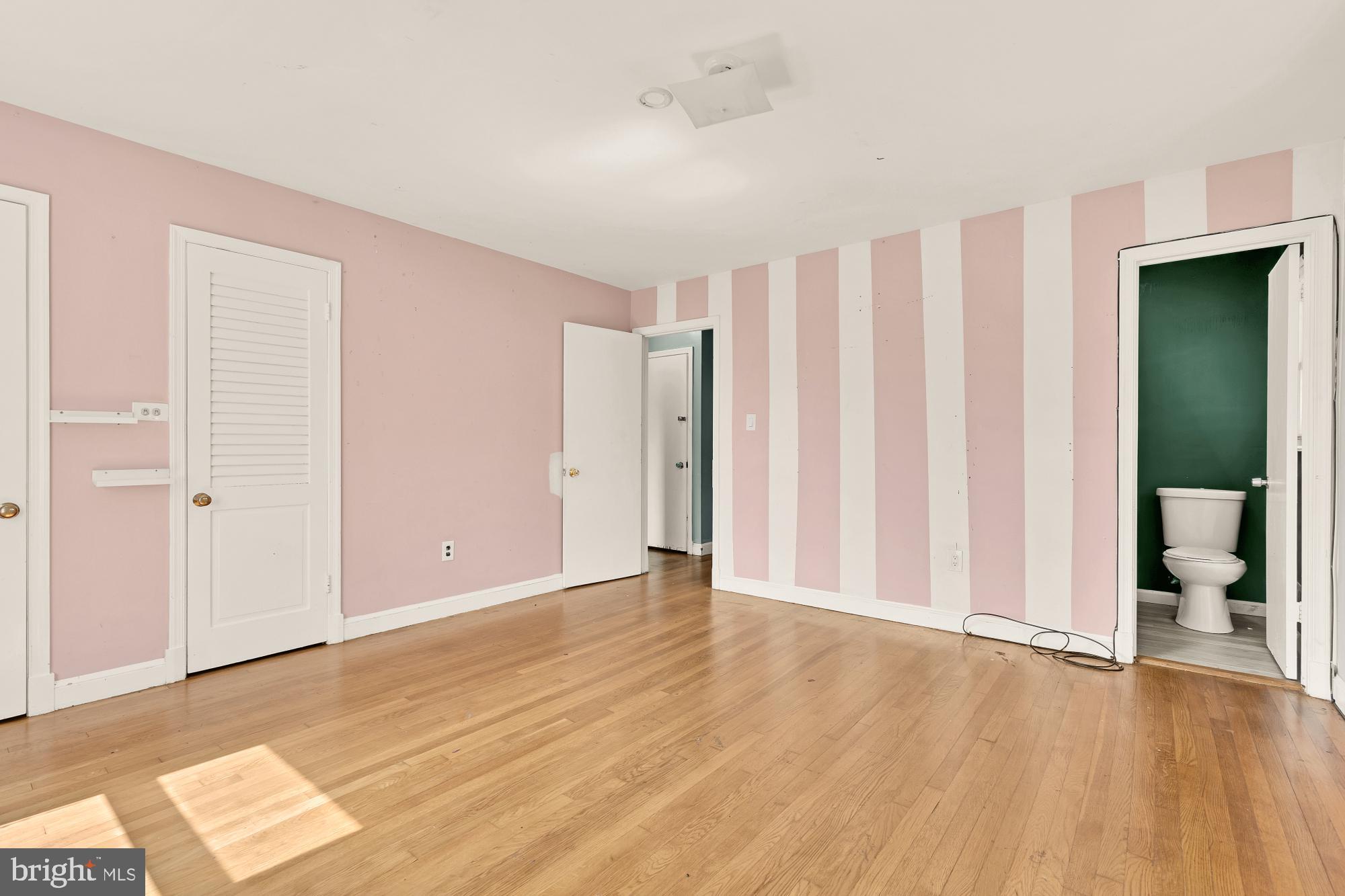 7302 Riverdale Road Lanham, MD 20706 - Photo 11 of 33 an empty room with wooden floor and closet