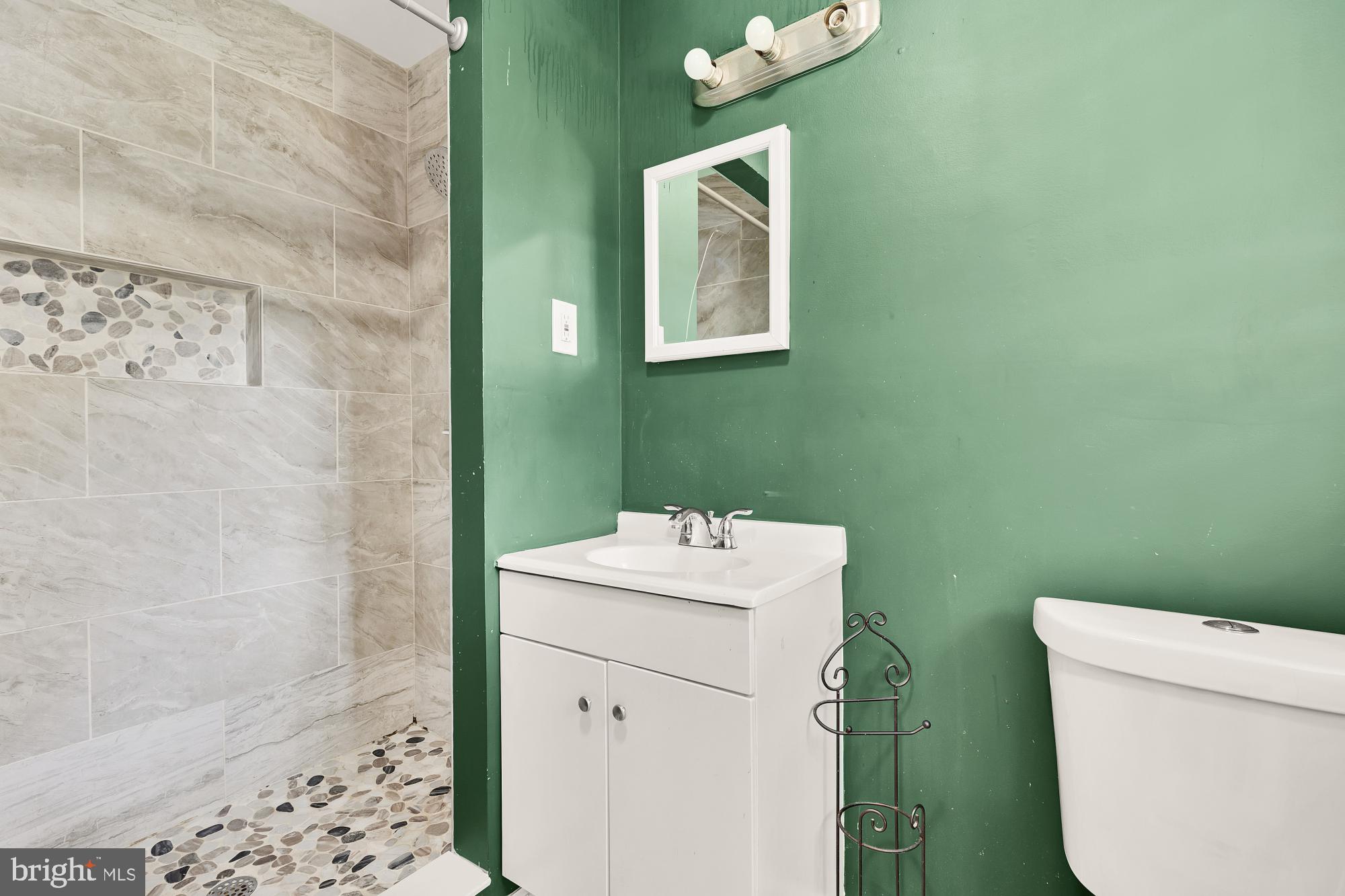 7302 Riverdale Road Lanham, MD 20706 - Photo 12 of 33 a bathroom with a sink mirror vanity and toilet