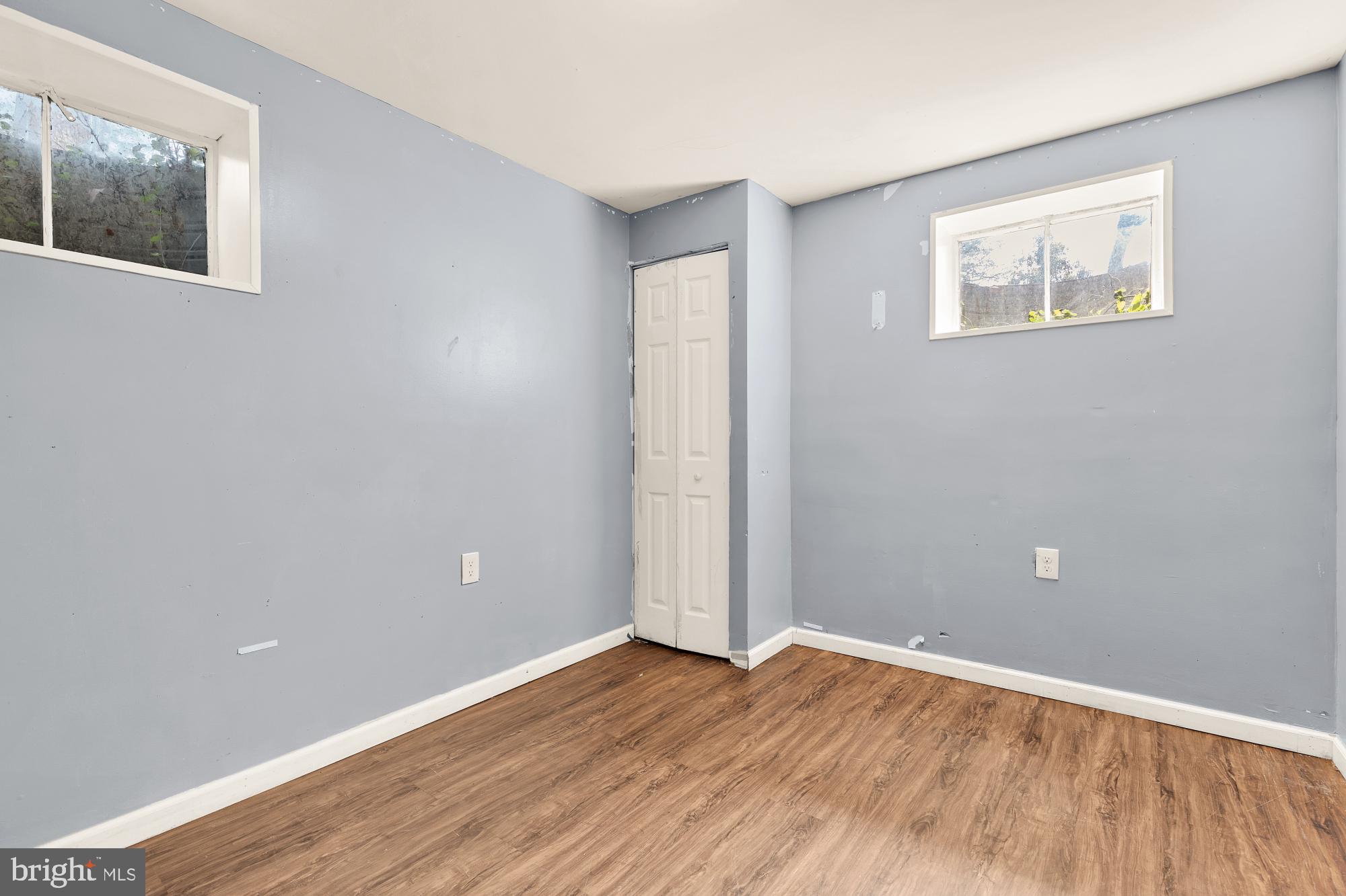 7302 Riverdale Road Lanham, MD 20706 - Photo 21 of 33 a view of an empty room with wooden floor and a window