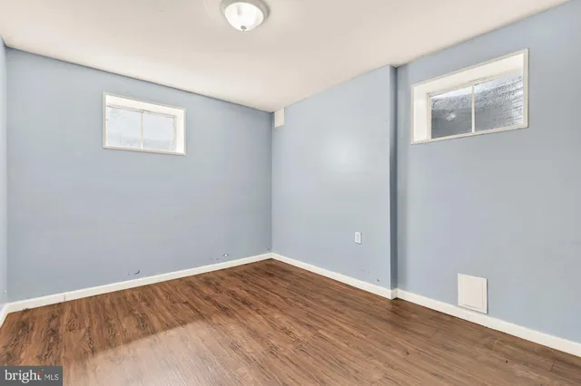 a view of a room with wooden floor and white walls
