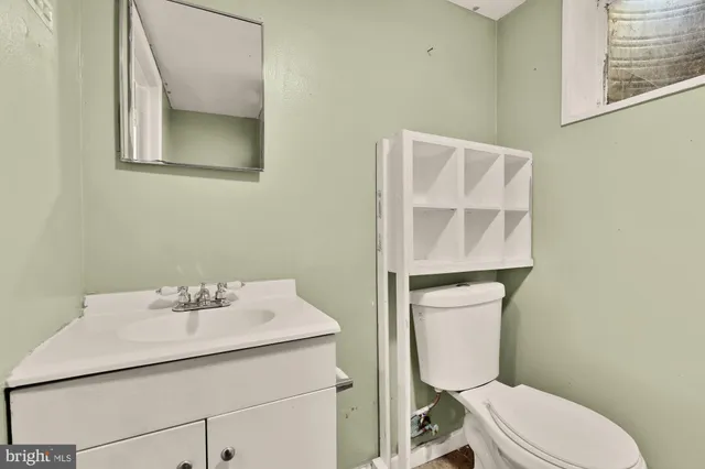a bathroom with a sink mirror and toilet