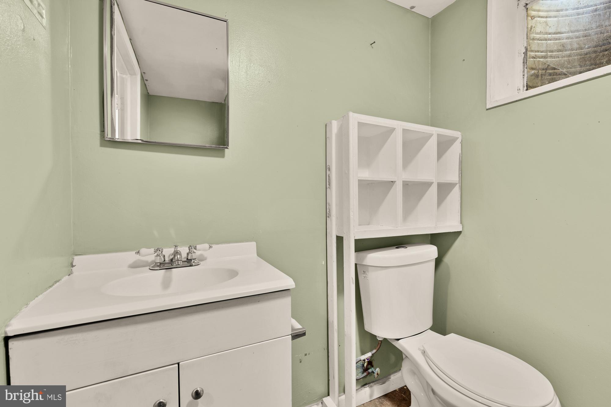 7302 Riverdale Road Lanham, MD 20706 - Photo 25 of 33 a bathroom with a sink mirror and toilet