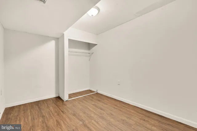 an empty room with wooden floor