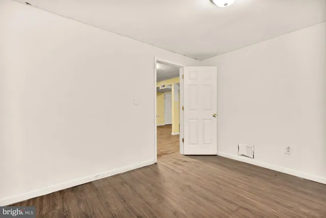 an empty room with wooden floor