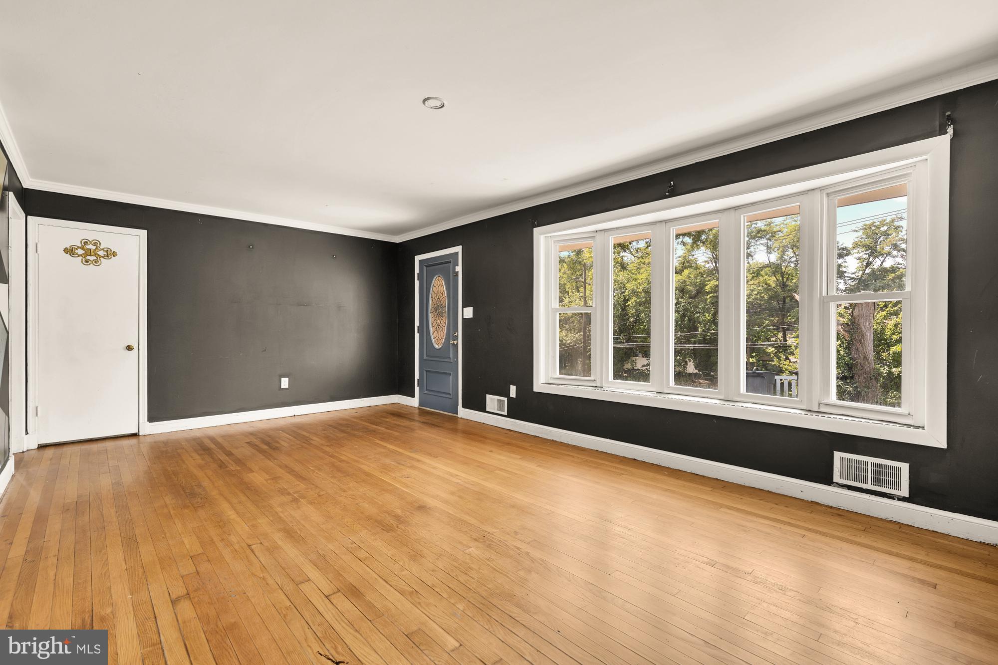 7302 Riverdale Road Lanham, MD 20706 - Photo 5 of 33 a view of an empty room with a window