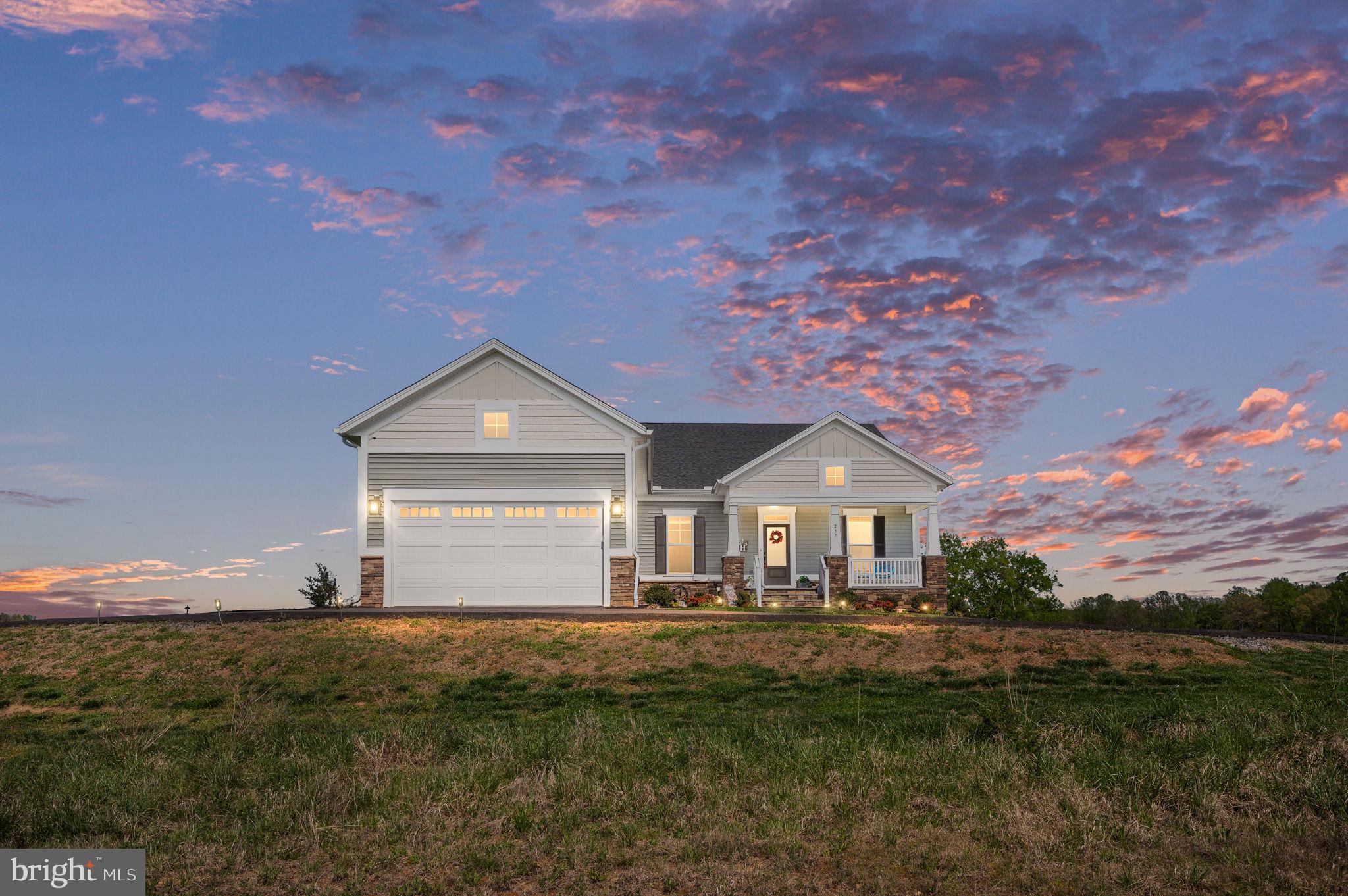 257 Rock Island Ridge Mineral, VA 23117 - Photo 6 of 128 a front view of a house with a yard and garage
