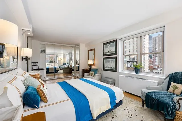 a bedroom with two beds and a large window