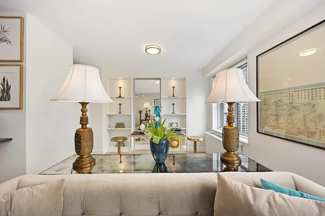 a living room with furniture and a lamp